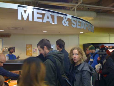 Crowd of people around the meat counter