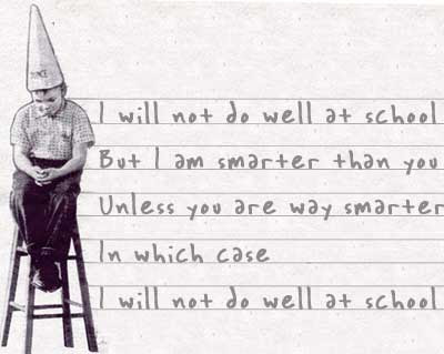 Old fashioned photo of a boy with a dunce cap on a stool, with handwriting behind - I will not do well in school/But I am smarter than you/Unless you are way smarter/In which case/I will not do well in school