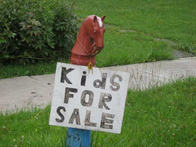 Hand-lettered sign reading Kids For Sale