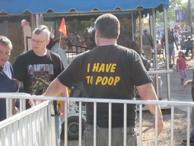 Back of a man's shirt that says I have to poop