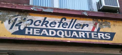 Hand-painted sign reading Rockefeller Headquarters