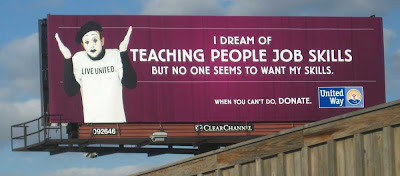 Dark billboard with a mime in a white shirt that says LIVE UNITED. Headline says I dream of teaching people job skills but no one seems to want my skills. Followed by the United Way  logo