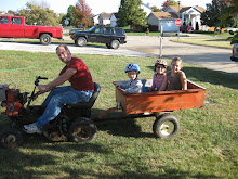 Kids going for a ride on our neighbor Ricks Lawn mower!