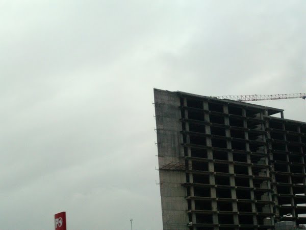 Concrete building under construction in Istanbul on a rainy day.