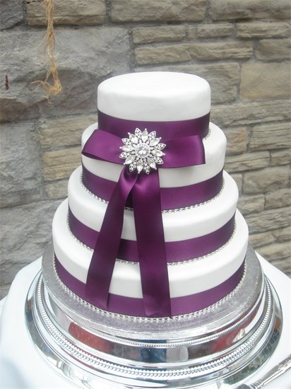 Picture of 4 Tier White Wedding Cake with Purple Ribbon by Any Excuse