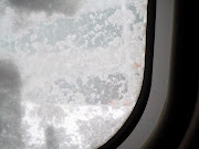 Our plane was to begin boarding at 8:20 a.m. and was to depart at 9:15. (view from inside plane dec )