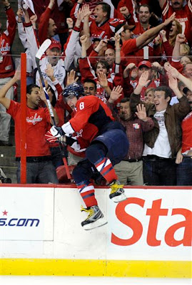 Alex Ovechkin, from Russia, leaps against the glass after scoring his third goal of the game against the Pittsburgh Penguins during the third period of Game 2