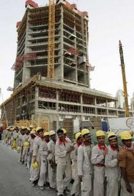 Dubai: Workers wait for a bus