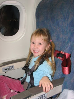 Young girl using CARES airplane safety harness during flight