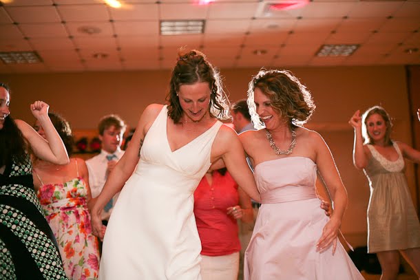 Ellie dancing with a friend at her wedding in downtown Milwaukee where Sound by Design was the DJ