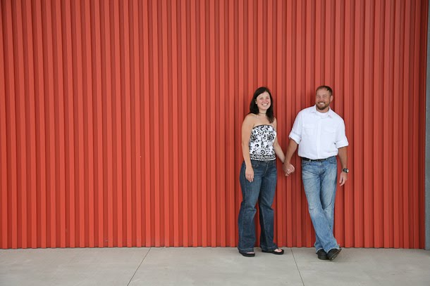Chris and Andrea pose for engagement portrait outside the Harley-Davidson museum