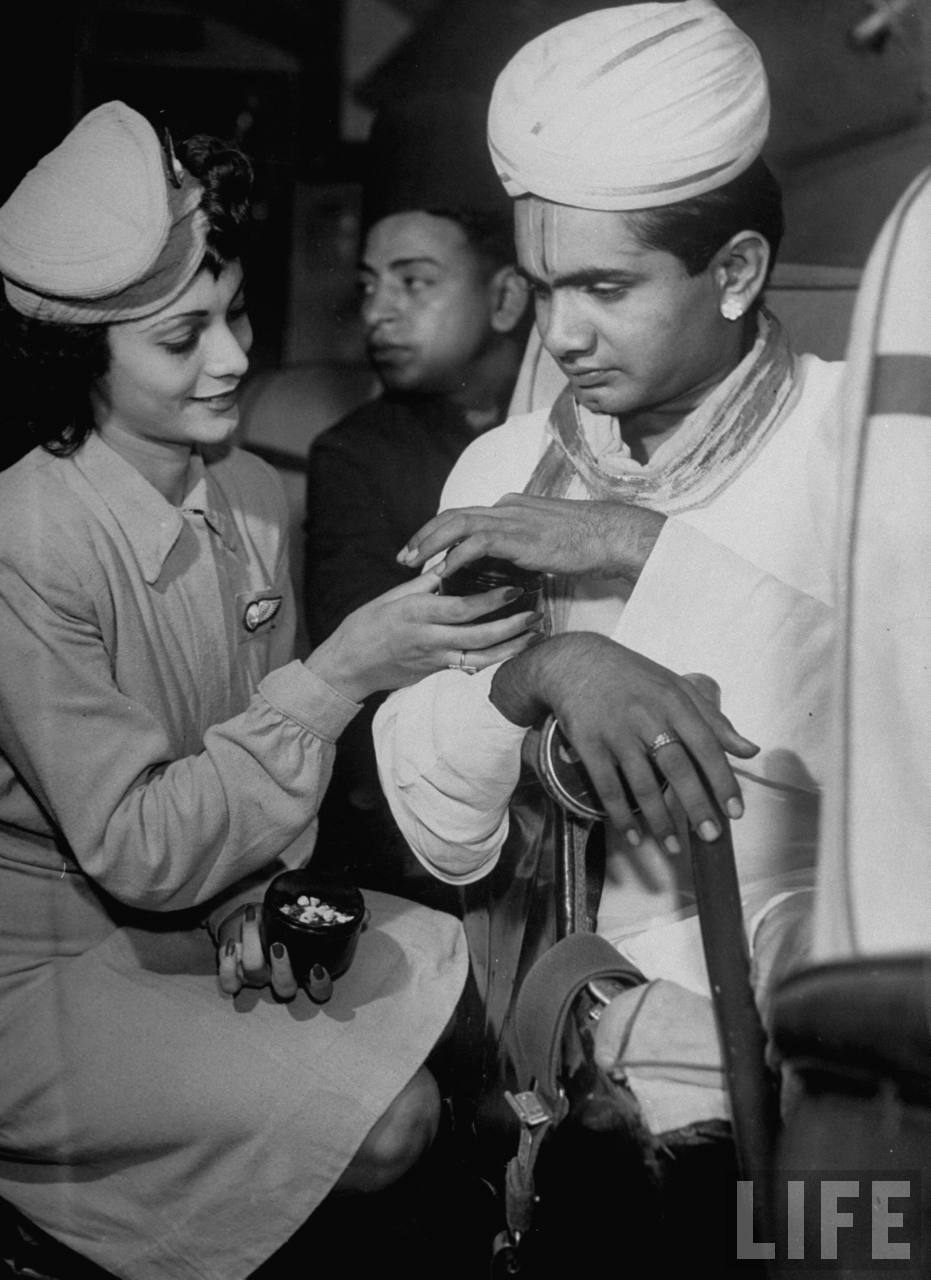 Air India flight attendant Monica Gilbert (L) passing out spices to Madrasi Brahmin passenger during trip across India. Air India flight attendant Monica Gilbert (L) passing out spices to Madrasi Brahmin passenger during trip across India.