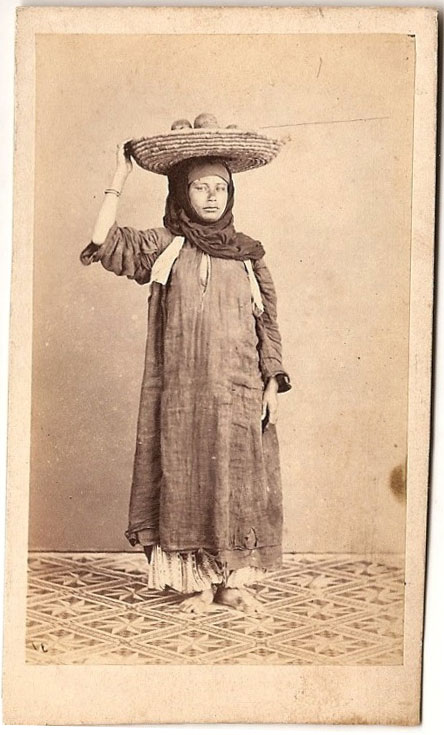 Standing Photograph of a Woman with a Fruit Busket on her head - 1875