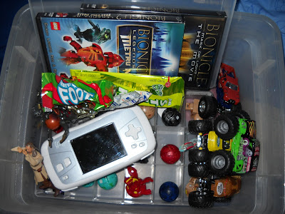 Toys, candy, and games in bin