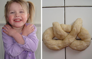 Happy child crossing arms and a pretzel