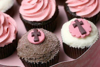 Chocolate cupcakes with brown, pink, and white frosting and pink and brown crosses on top