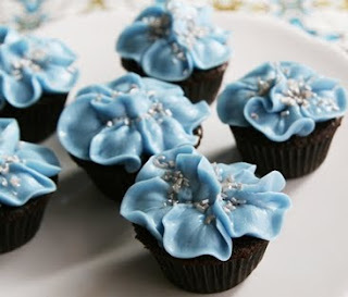Chocolate cupcakes with blue frosting flower tops