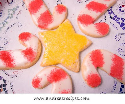 Frosted sugar cookies with sprinkles in star and candy cane shapes