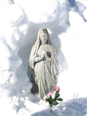 Statue of Saint mary in the snow