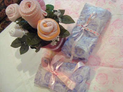 Baby supplies rose bouquet next to gifts 