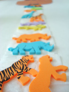 Crepe paper strip with pairs of foam animals all up it