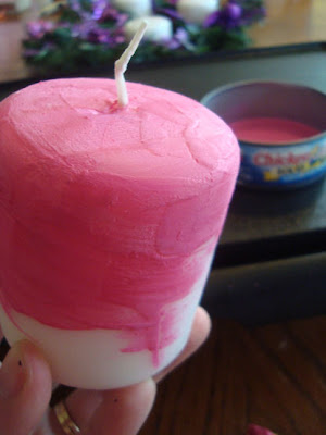 Pillar candle coated in pink crayon wax