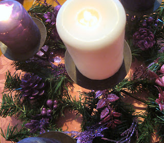 White and purple candles in a wreath