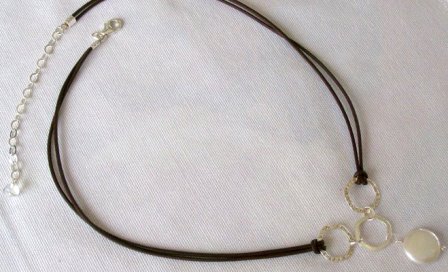 Sterling silver rings and large freshwater coin pearl on leather necklace - $34