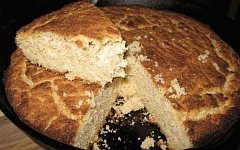 A color photo of a pone or round cake of cornbread.