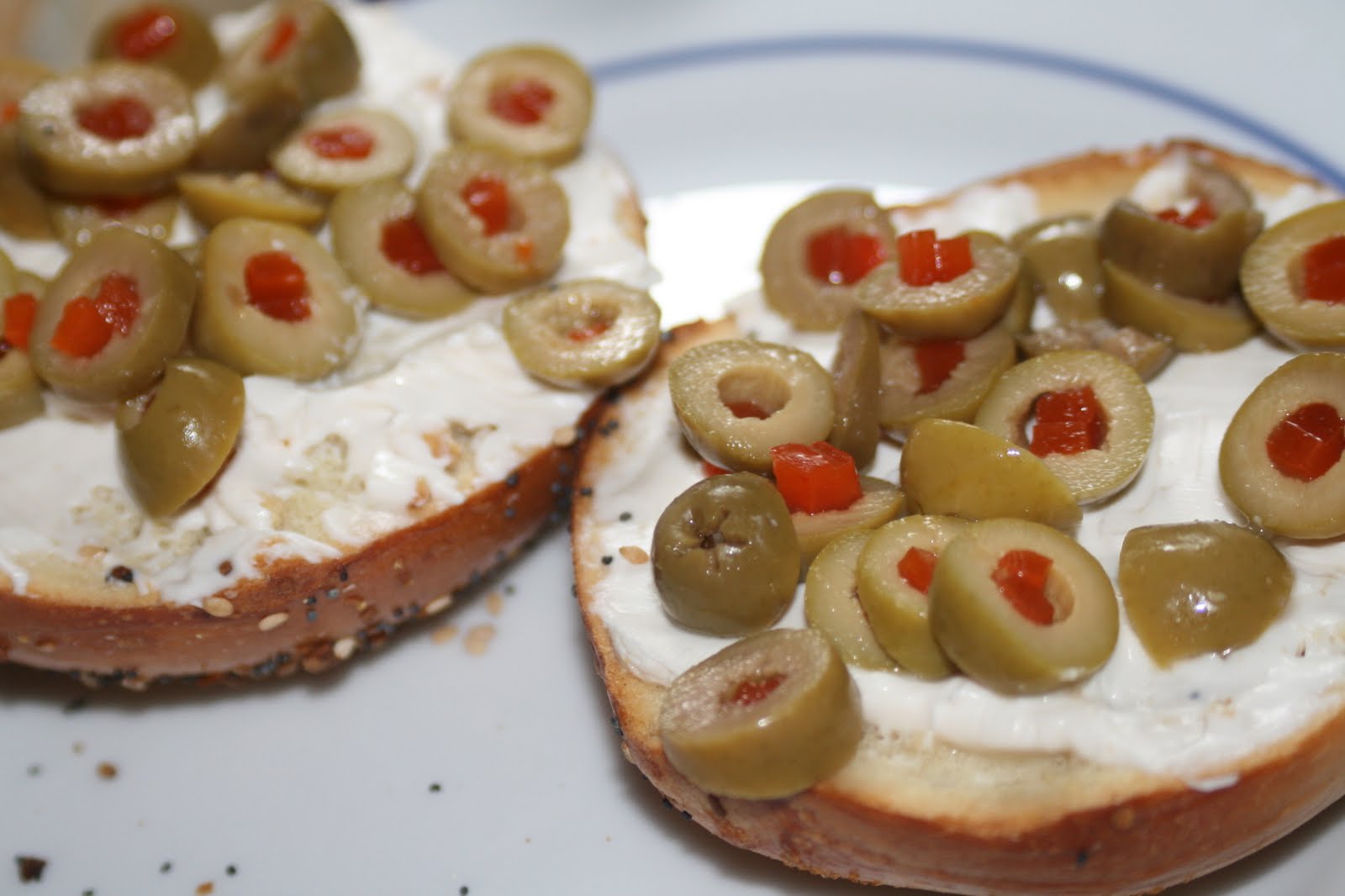 Image result for toasted bagel with cream cheese and olives