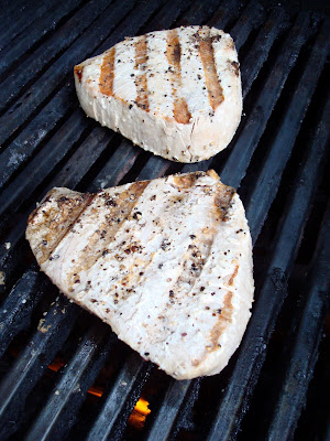 Two ahi tuna steaks on a grill. 