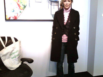 pink and black outfit, casual work outfit, pink turtleneck with a lace top over, long black military coat, low side bun, wide leg jeans, 2008 style