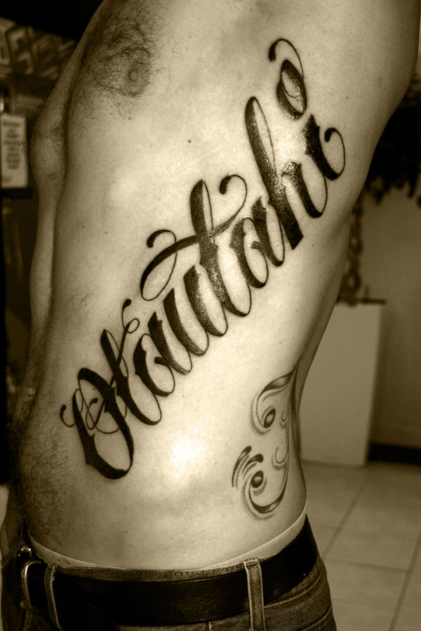 Lettering into a tattoo is to have it within or accompanying a picture 