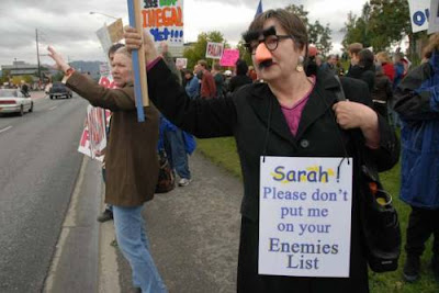 Masked protester with sign at anti-Palin rally in Anchorage - 'Sarah, please don't put me on your enemies list'. 