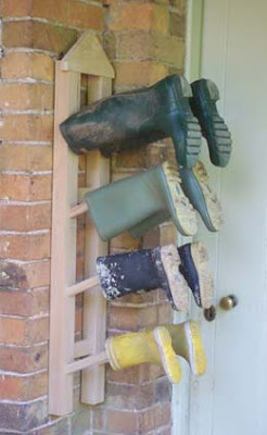 hanging (wall-mounted) boot rack with 4 pairs of boots on it