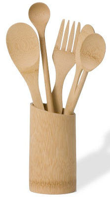 bamboo utensil holder with wooden spoons and a wooden fork in it