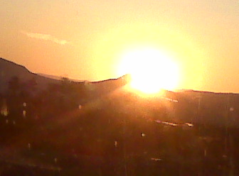 Watchin the Sun peekin over the horizon