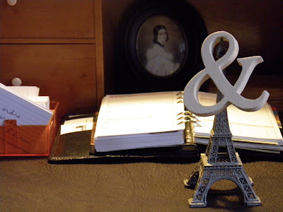 Sekretär mit Vokabelkartei, Kalender, Eiffelturm und einem &-Zeichen aus Holz