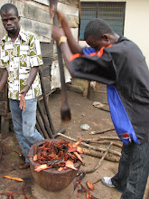 Musah and David pounding Badie Bark in Ntonso