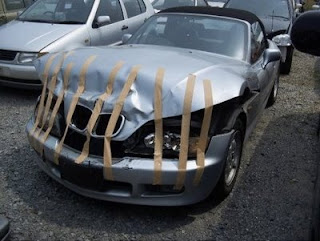 funny smashed car photo bmw held together with tape