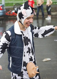 crazy funny photo of stupid guy in a cow costume for fancy dress party