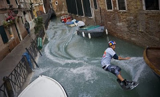 funny venice photo of guy on waterski riding through the canals past the gondolas