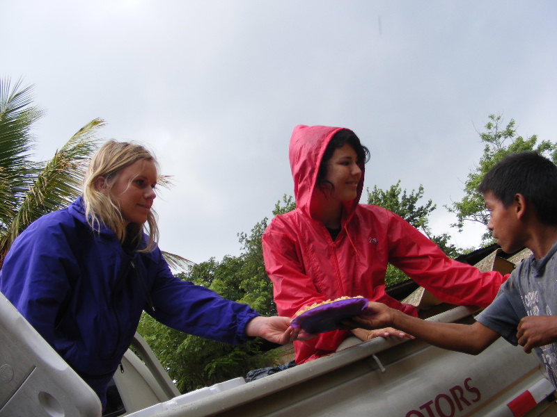 Katie and Ashley pass out food in the jungle...