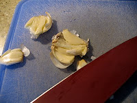 A close up photo of smashed garlic cloves.