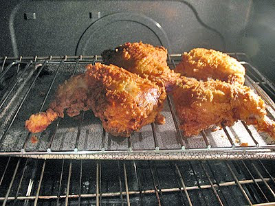 A photo of crispy fried chicken pieces in the oven.