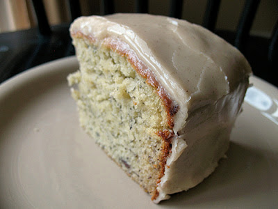 A close up photo of a slice of bananas and cream Bundt cake with brown butter glaze.