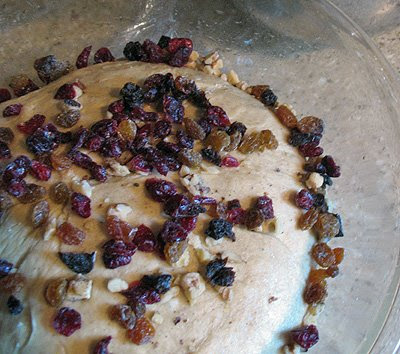 A photo of raisins, cranberries and nuts added to the dough.