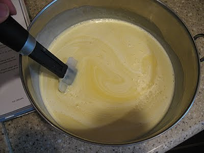 An overhead photo of cream being stirred into the custard and chocolate mixture.