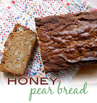 An overhead photo of a loaf of honey pear bread with a slice on the side.