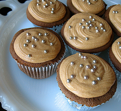 A close up photo of Mexican chocolate cupcakes with dulce de leche frosting.